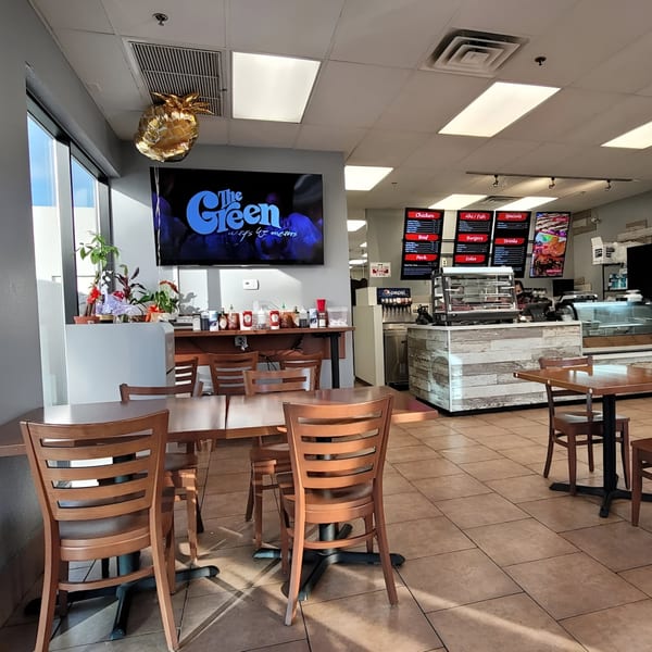 Interior of Generations Kitchen Hawaiian Food, showing dining tables, a service counter, and menu boards.